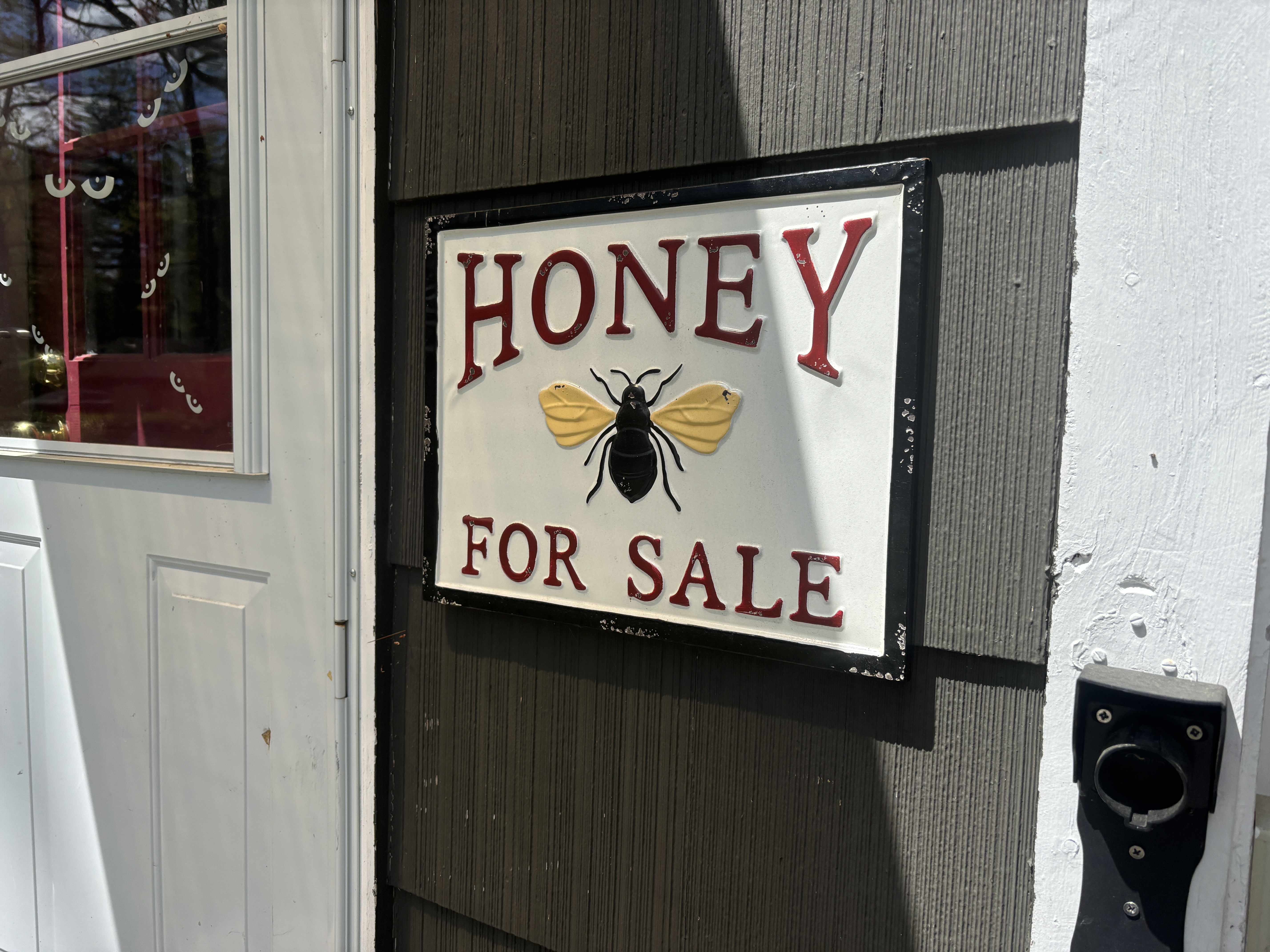 The "Honey For Sale" sign on the property — a long-standing fixture